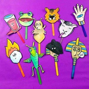 May include: A set of 10 colorful paper puppets on sticks. The puppets include a tiger, a frog, a bug, a sheep, a hand, a fire, a grasshopper, a person with a hat, a pharaoh, and a glass of juice. The puppets are perfect for storytelling or imaginative play.