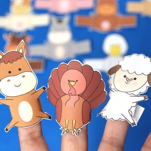 May include: A set of finger puppets featuring a brown horse, a brown turkey, and a white sheep. The puppets are made of paper and have a simple, cartoon-like design.