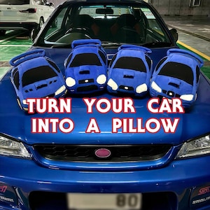 May include: Four blue plush car-shaped pillows are arranged on the bonnet of a blue car. The text TURN YOUR CAR INTO A PILLOW is overlaid in red letters. The pillows feature black windscreens, white headlights, and spoilers on the back.