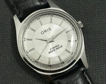 Reloj de pulsera ORIS vintage con esfera plateada, movimiento mecánico de cuerda manual FHF ST-96, fabricado en Suiza.
