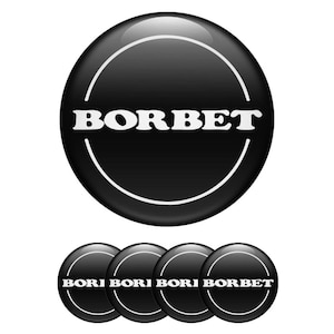 Puede incluir: Un conjunto de pegatinas redondas negras brillantes con la palabra "BORBET" en blanco, en forma de arco. Una línea blanca curva bordea la parte superior e inferior del texto. Cuatro pegatinas más pequeñas con el mismo diseño debajo.