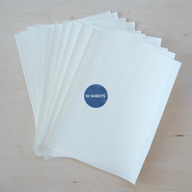 May include: A stack of white paper sheets with a blue circular sticker that reads "10 SHEETS". The paper is arranged in a fan shape, with the sticker placed on the front sheet.