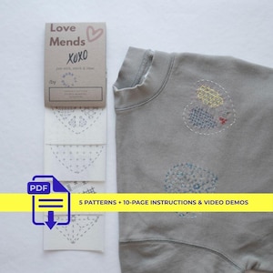 May include: A gray sweatshirt with embroidered patches and a matching instruction card. The card reads "Love Mends XOXO" and includes a PDF icon with the text "5 PATTERNS + 10-PAGE INSTRUCTIONS & VIDEO DEMOS".