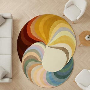 May include: A large circular area rug featuring a vibrant, swirling pattern of radiating curved segments in a spectrum of colors including deep red, orange, yellow, cream, light blue, and green, creating a dynamic, multi-colored spiral design.