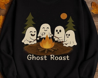 May include: Black sweatshirt with a graphic of four cartoon ghosts roasting marshmallows over a campfire. The text "Ghost Roast" is below the image. The background includes trees, a moon, and stars.