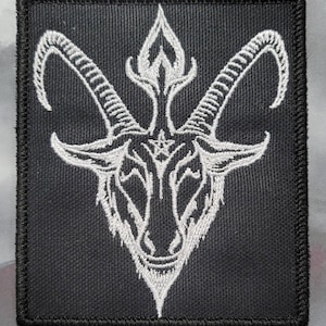 May include: White embroidered patch on a black background featuring a goat's head with horns and a pentagram.