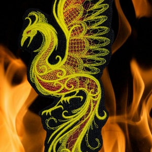May include: Yellow and red embroidered phoenix patch with intricate details. The phoenix is depicted with its wings spread and a long tail.