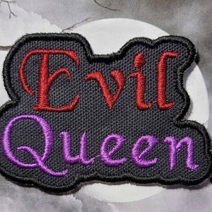 May include: Black embroidered patch with the words "Evil Queen" in red and purple thread.