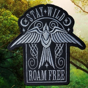 May include: Black embroidered patch with a silver bird design and the text "Stay Wild Roam Free".