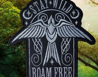 May include: Black embroidered patch with a silver bird design and the text "Stay Wild Roam Free".