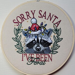 Embroiderd raccoon hooped art.Santa