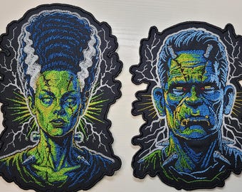 May include: Two embroidered patches featuring the Bride of Frankenstein and Frankenstein's monster. Both designs showcase vibrant green and blue thread work, detailed facial features, and white lightning bolt accents against a black background.