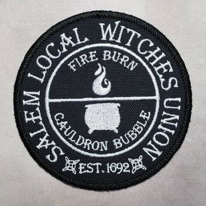 May include: Black and white embroidered patch with the text "Salem Local Witches Union" around the edge. The center of the patch features a cauldron with flames and the text "Fire Burn Cauldron Bubble Est. 1692".