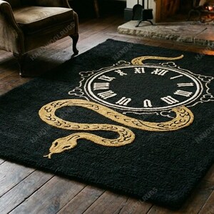 May include: Black rectangular rug with a gold snake design and a clock face in the center. The clock face has Roman numerals. The rug is on a hardwood floor.