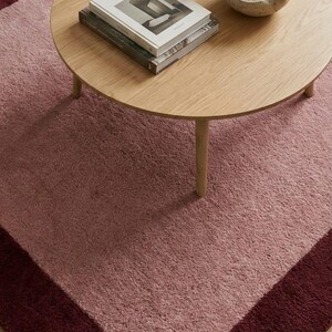 Blush pink area rug with dark border
Modern minimalist living room carpet
Soft pink rug under round coffee table
Elegant solid color bedroom rug
Contemporary blush carpet for home
Luxury pink area rug with border
Minimalist rectangular living room rug
Soft plush modern floor carpet
Large pink rug for cozy interior
Warm tone blush area carpet
Modern aesthetic home decor rug
Thick pile solid pink carpet
