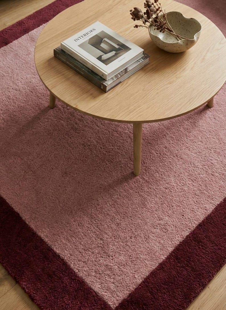 Blush pink area rug with dark border
Modern minimalist living room carpet
Soft pink rug under round coffee table
Elegant solid color bedroom rug
Contemporary blush carpet for home
Luxury pink area rug with border
Minimalist rectangular living room rug
Soft plush modern floor carpet
Large pink rug for cozy interior
Warm tone blush area carpet
Modern aesthetic home decor rug
Thick pile solid pink carpet