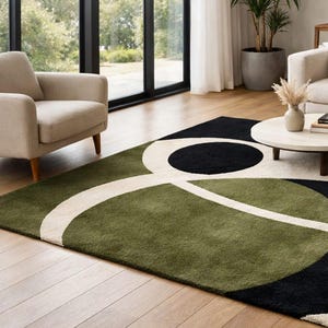 modern abstract area rug for living room decor
green black cream geometric rug design
handmade wool rug for modern home
contemporary abstract rug on wooden floor
luxury area rug with circular pattern
soft wool rug for cozy interiors
modern designer rug for minimalist decor
abstract floor rug for stylish living room
geometric pattern rug in green tones
hand tufted rug for elegant interiors
modern home decor rug inspiration
statement area rug with bold shapes