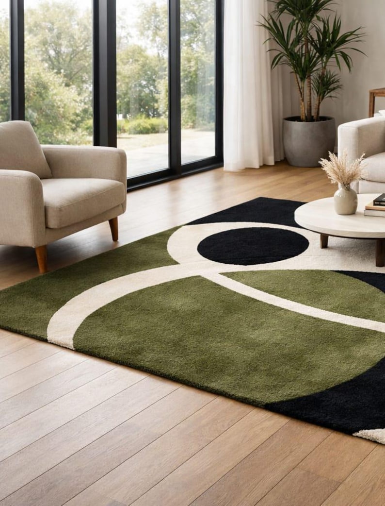 modern abstract area rug for living room decor
green black cream geometric rug design
handmade wool rug for modern home
contemporary abstract rug on wooden floor
luxury area rug with circular pattern
soft wool rug for cozy interiors
modern designer rug for minimalist decor
abstract floor rug for stylish living room
geometric pattern rug in green tones
hand tufted rug for elegant interiors
modern home decor rug inspiration
statement area rug with bold shapes