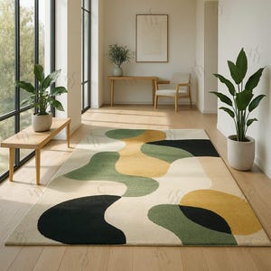 May include: A rectangular area rug with an abstract design in a neutral color palette. The rug features large, organic shapes in black, green, and yellow against a cream background. The rug is placed on a wooden floor in a well-lit room.