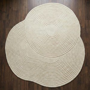 contemporary circle rug,
round rug modern decor,
neutral round carpet,
handmade wool rug round,
round rug cozy interior,
minimal round floor rug,
ivory wool circle rug,
round rug elegant look,
soft texture round rug,
modern lounge round rug,
stylish round carpet,
round rug interior decor,
premium wool round rug,
round rug neutral decor,
handcrafted round rug,
round rug aesthetic home,
living area round rug,