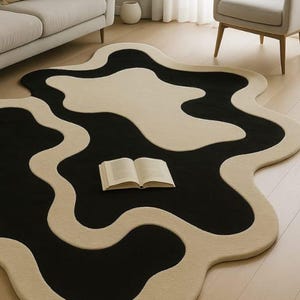 Abstract wavy black ivory area rug
Modern organic shape wool rug
Hand tufted abstract living room rug
Luxury black and ivory designer rug
Contemporary sculptural area rug
Minimal modern home decor rug
Organic flowing shape floor rug
Statement rug for modern interiors
Soft wool abstract area rug
Art inspired modern rug
Neutral black ivory floor decor