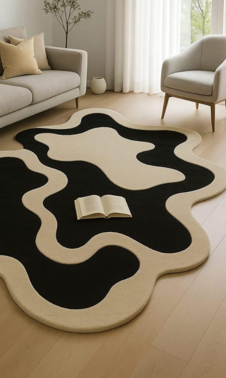 Abstract wavy black ivory area rug
Modern organic shape wool rug
Hand tufted abstract living room rug
Luxury black and ivory designer rug
Contemporary sculptural area rug
Minimal modern home decor rug
Organic flowing shape floor rug
Statement rug for modern interiors
Soft wool abstract area rug
Art inspired modern rug
Neutral black ivory floor decor