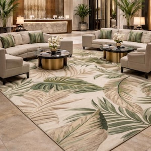 May include: A hotel lobby with a large rug featuring a tropical leaf design in green and beige. The room has beige sofas, armchairs, and round coffee tables with gold bases. The room has a welcoming atmosphere.