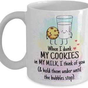 Può includere: Tazza in ceramica bianca con un design stravagante con un biscotto dei cartoni animati e un bicchiere di latte. La tazza ha il testo: "When I dunk MY COOKIES in MY MILK, I think of you (& hold them under until the bubbles stop)."