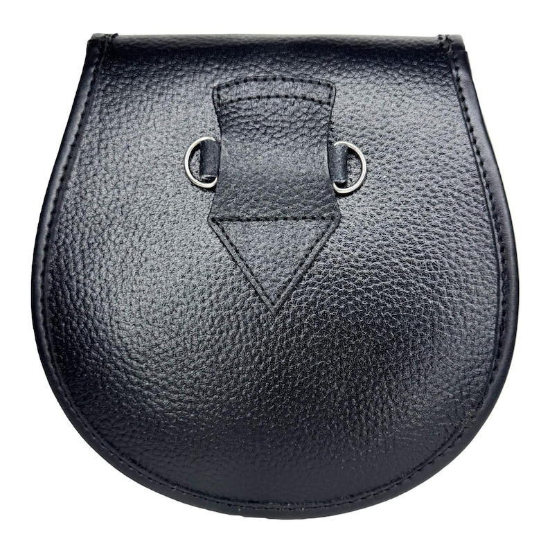 May include: A black leather sporran with a textured surface. The sporran has a rounded bottom and a flap closure with two silver-colored metal rings. The flap has a triangular design stitched into it.