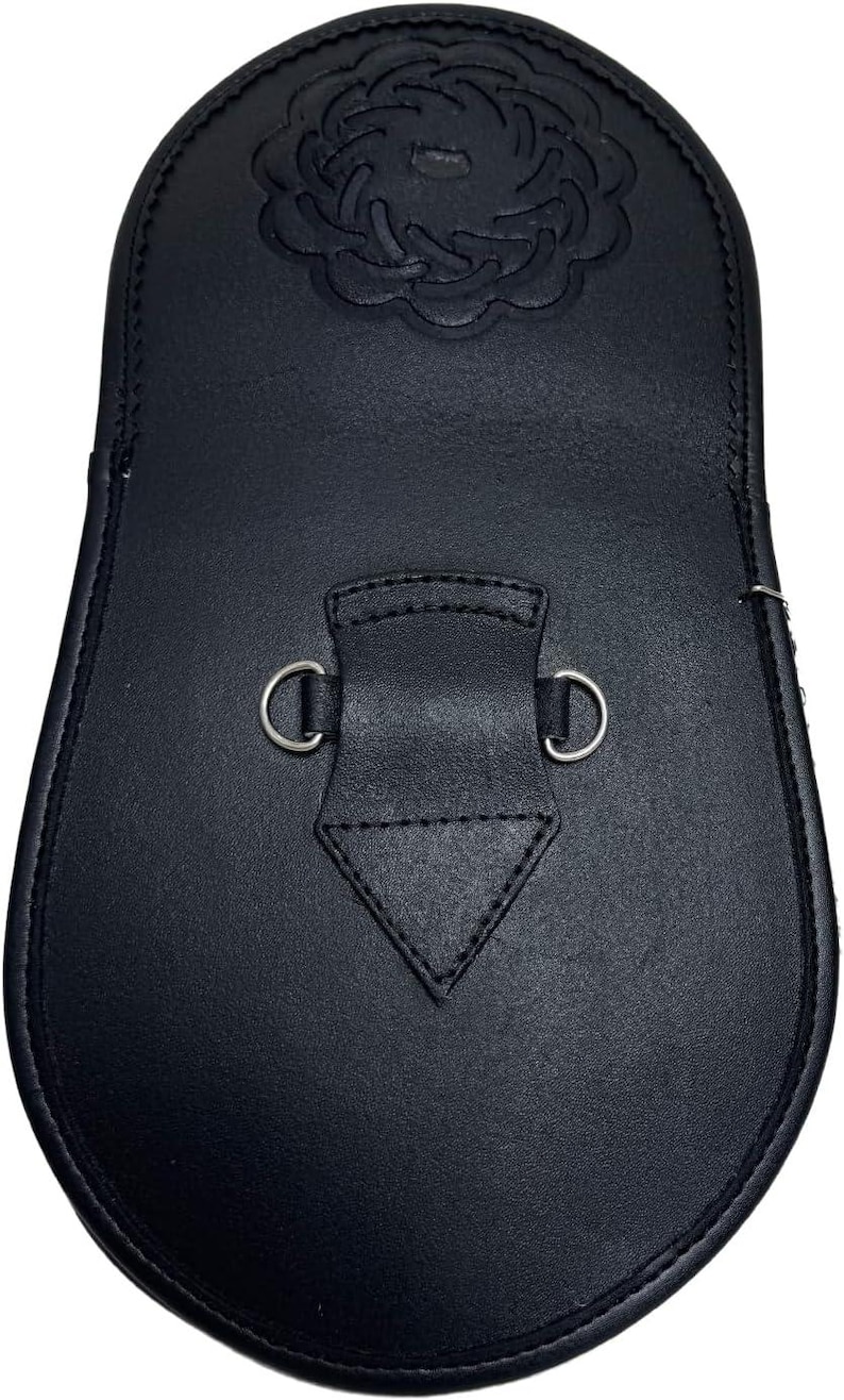 May include: A black leather sporran with a decorative embossed floral design at the top. The sporran features a flap with a stitched diamond shape and two metal D-rings for attachment.