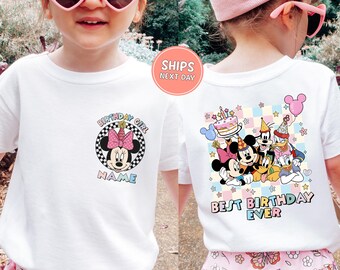 May include: White t-shirt featuring Minnie Mouse with a pink bow and the text "Birthday Girl" on the front. The back of the shirt displays Mickey Mouse, Donald Duck, and Goofy with the words "Best Birthday Ever".