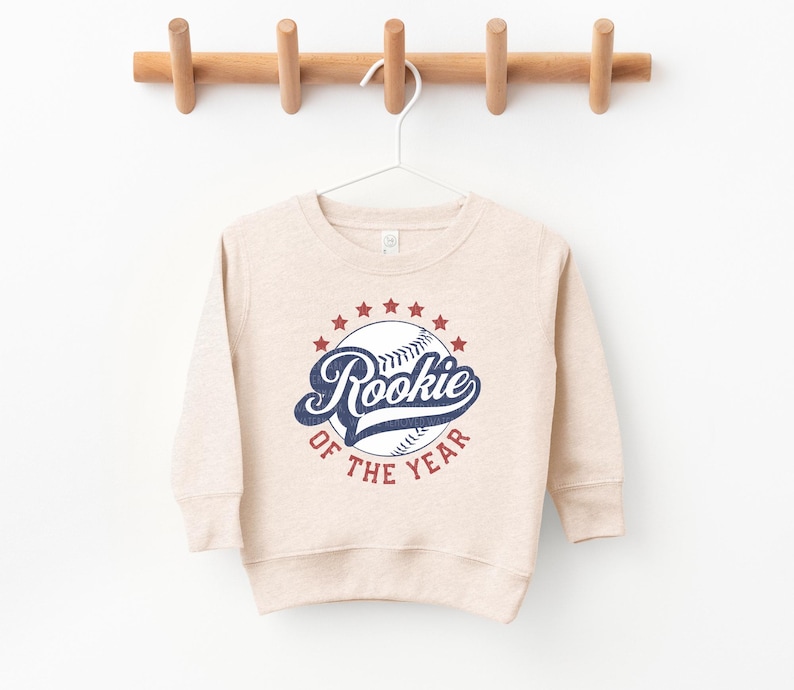 a baseball sweatshirt hanging on a wooden hanger