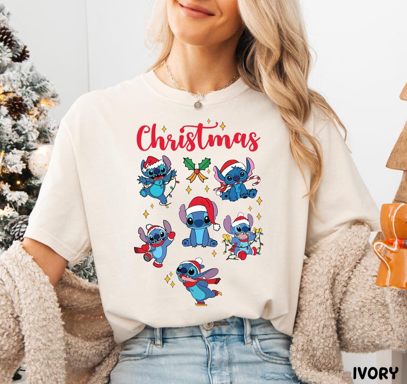 A woman wearing a white t-shirt with a Christmas-themed design featuring cartoon characters.