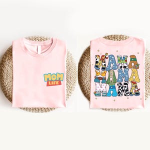 a pink shirt with cartoon characters on it