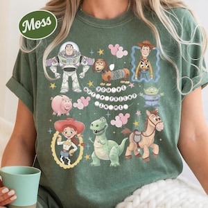 A person wearing a green t-shirt with various cartoon characters and a message printed on it.