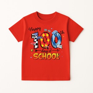 A red t-shirt with a graphic design celebrating the 100th day of school.