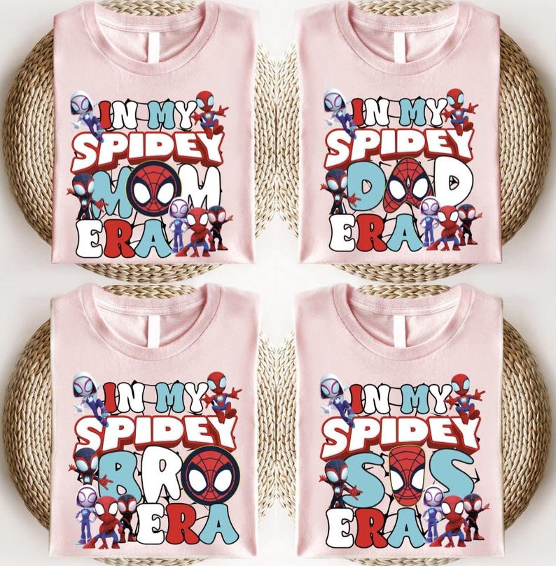 four pink t-shirts with the text "IN MY SPIDERY MOM ERA" printed on them. The shirts are arranged in a grid-like pattern, with each shirt placed on top of a woven basket.