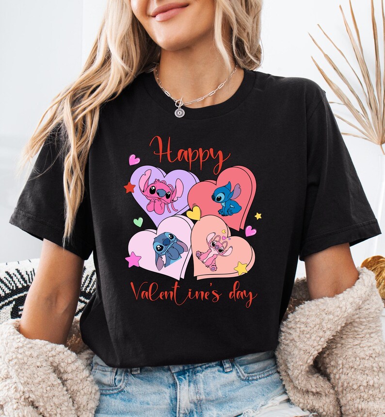 A woman wearing a black t-shirt with a graphic design featuring four cartoon characters and the text "Happy Valentine's day".