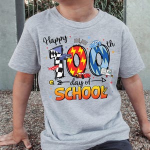 A gray t-shirt with a graphic design celebrating the 100th day of school.