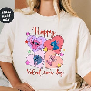 A white t-shirt with a graphic design featuring characters from the Disney animated film "Stitch" and the text "Happy Valentine's day".