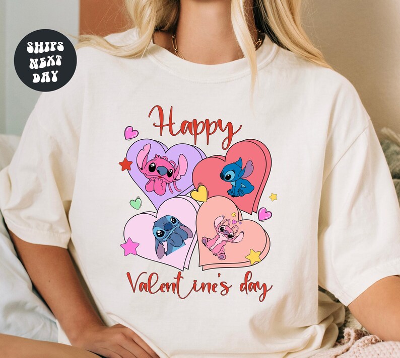 A white t-shirt with a graphic design featuring characters from the Disney animated film "Stitch" and the text "Happy Valentine's day".