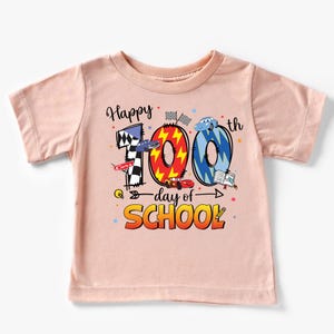 A pink t-shirt with a graphic design celebrating the 100th day of school.
