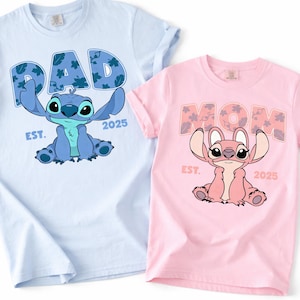 two t-shirts with cartoon characters on them, one in blue and one in pink.