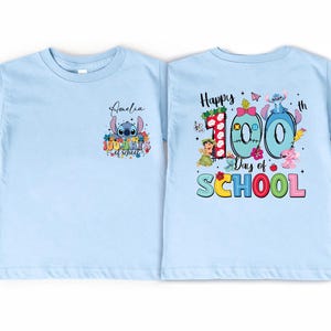A light blue t-shirt with a colorful graphic design on the back, celebrating the 100th day of school.