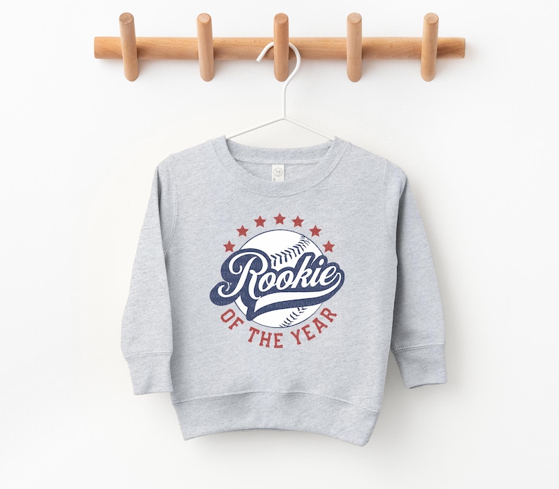 a baseball sweatshirt hanging on a wooden hanger