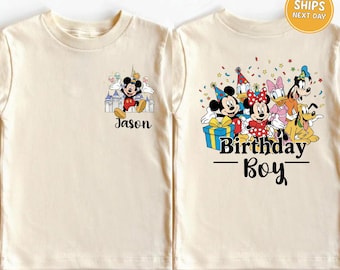 May include: Cream-colored t-shirt featuring Mickey Mouse and friends. The front displays Mickey with the name "Jason". The back shows Mickey, Minnie, Donald, Daisy, and Goofy with the text "Birthday Boy".