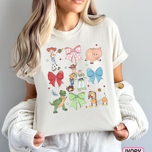 a woman holding a pillow with cartoon characters on it
