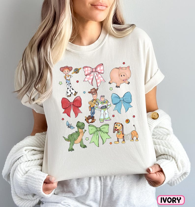 a woman holding a pillow with cartoon characters on it
