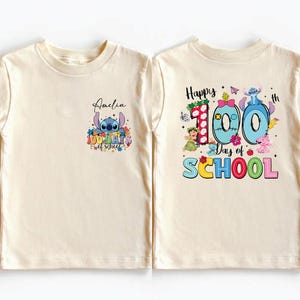 two white t-shirts with colorful designs and text related to a 100th day of school celebration.