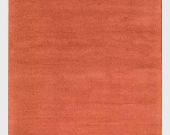 Alfombra de lana naranja tejida a mano: suave, duradera y de color liso.
